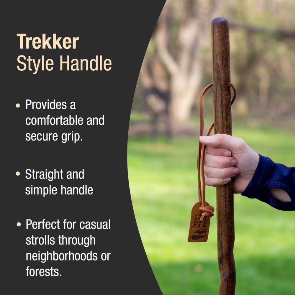 Wooden handle with a hand holding it, set against a blurred natural background.
