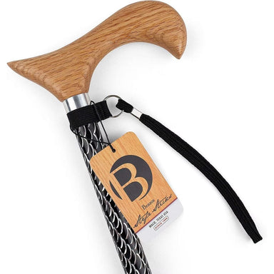 Wooden walking cane with black patterned handle and branded tag on a white background