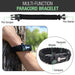Black multi-function paracord bracelet with various tools on a wrist, outdoors.