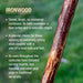 Ironwood stick with descriptive text on a blurred green background