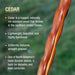 Wooden stick with text about cedar wood properties on a blurred green background