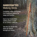 Handcrafted walking stick leaning against a tree with text about craftsmanship.