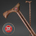 Wooden walking cane with US Coast Guard Veteran engraving on a dark background