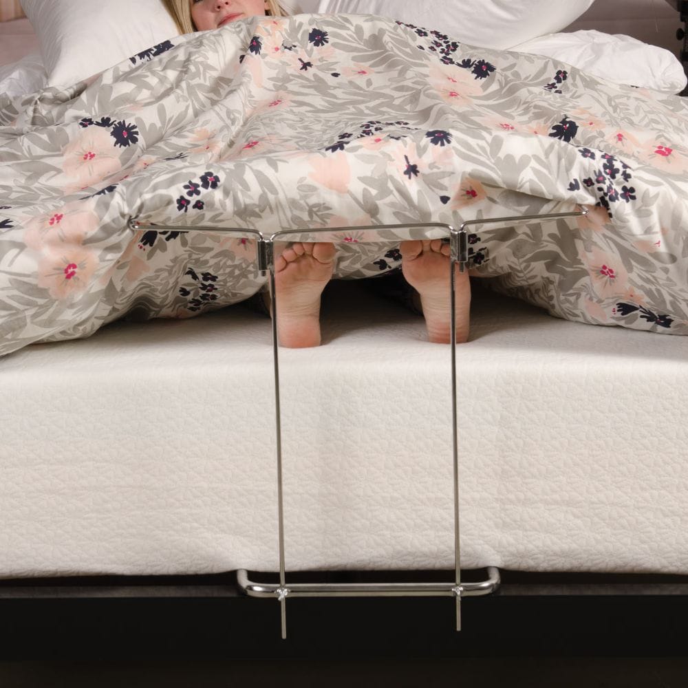 Clear acrylic stand on a bed with floral bedding