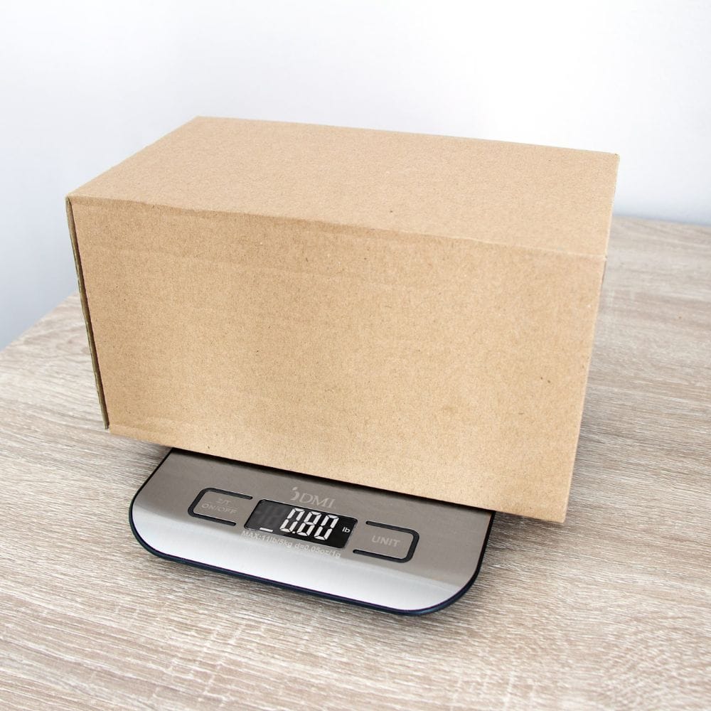 Kraft paper box on a digital kitchen scale with a white background
