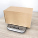 Kraft paper box on a digital kitchen scale with a white background