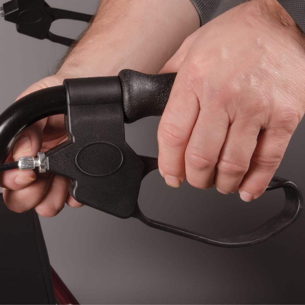 Close-up of a person holding a black archery bow with a gray background