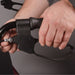 Close-up of a person holding a black archery bow with a gray background