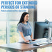 Woman at a standing desk with text about extended periods of standing