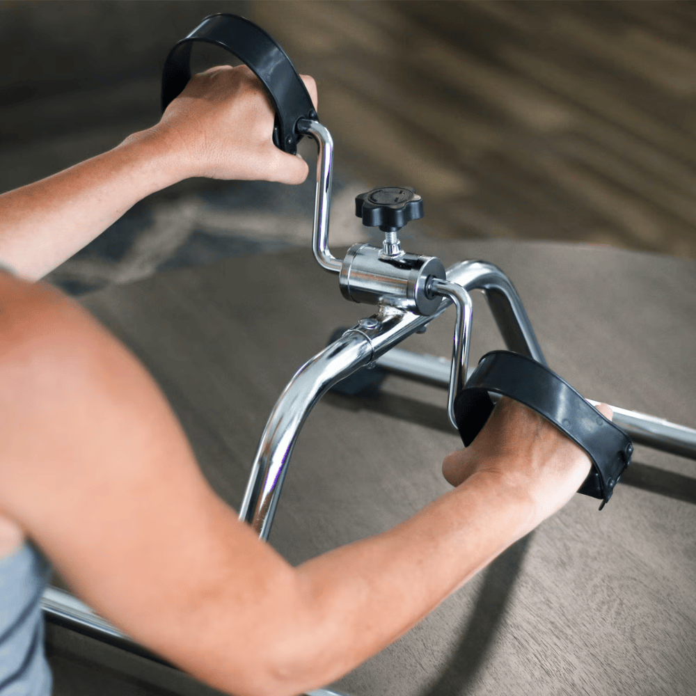 Person using a resistance band exercise machine with blurred background