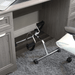 Small exercise bike under a desk in an office setting