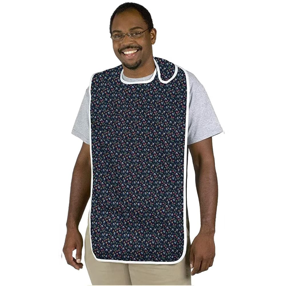 Man wearing a navy floral apron over a white shirt on a white background