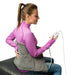 Woman using a back massager on a white background