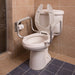 Toilet with raised seat and grab bars in a tiled bathroom