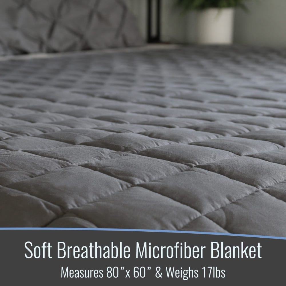 Gray soft breathable microfiber blanket on a bed with text about dimensions and weight.