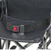 Black seat belt with a red 'PRESS' button on a wheelchair seat.