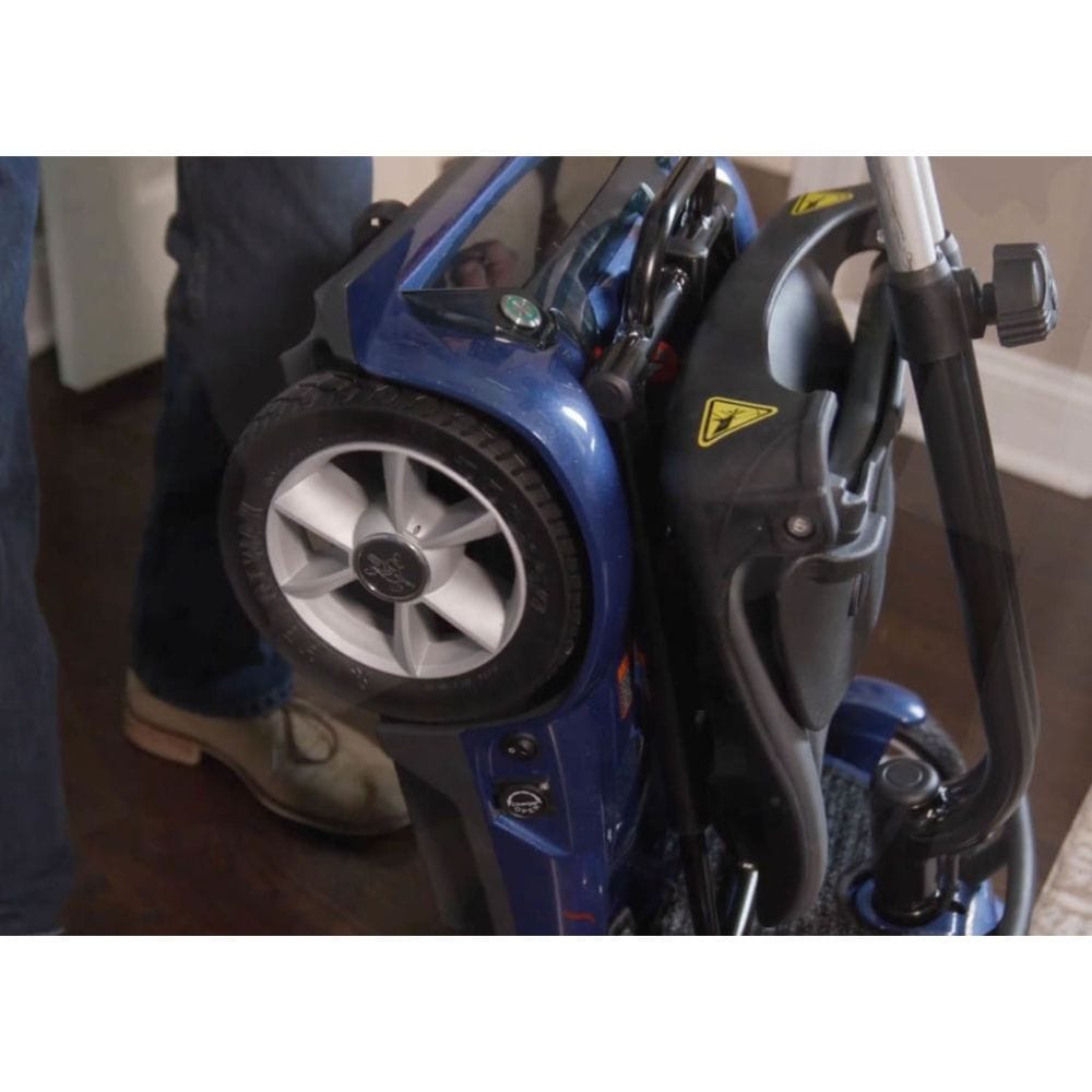 Close-up of a blue power washer with a person partially visible in the background.