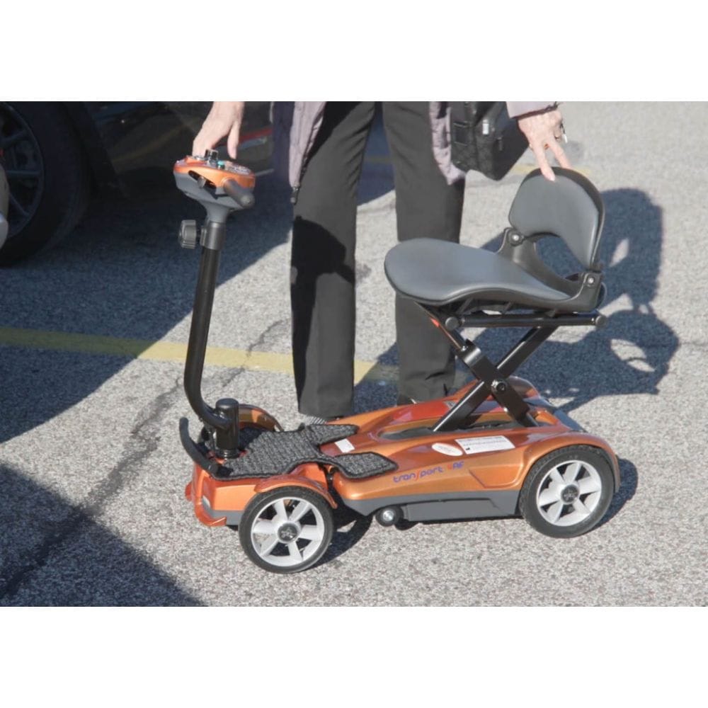 Orange and black mobility scooter on a paved surface