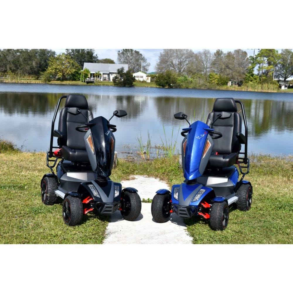 Two mobility scooters, one black and one blue, parked on grass near a lake.