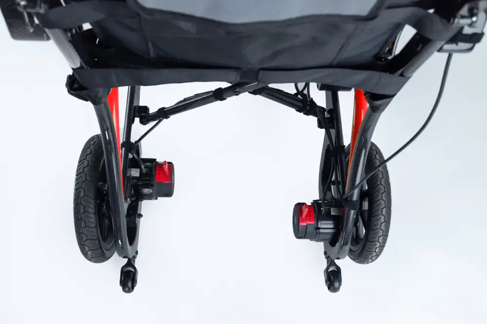 Rear view of the Monarch Mobility Ezi-Fold Carbon showing the drive wheels, motors, and small anti-tip wheels.