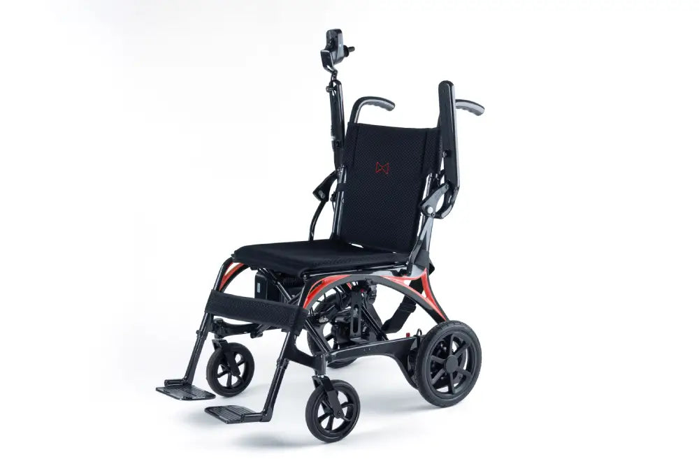 Monarch Mobility Ezi-Fold Carbon power wheelchair with black seating, orange frame accents, raised armrests, joystick control, and swing-away footrests.