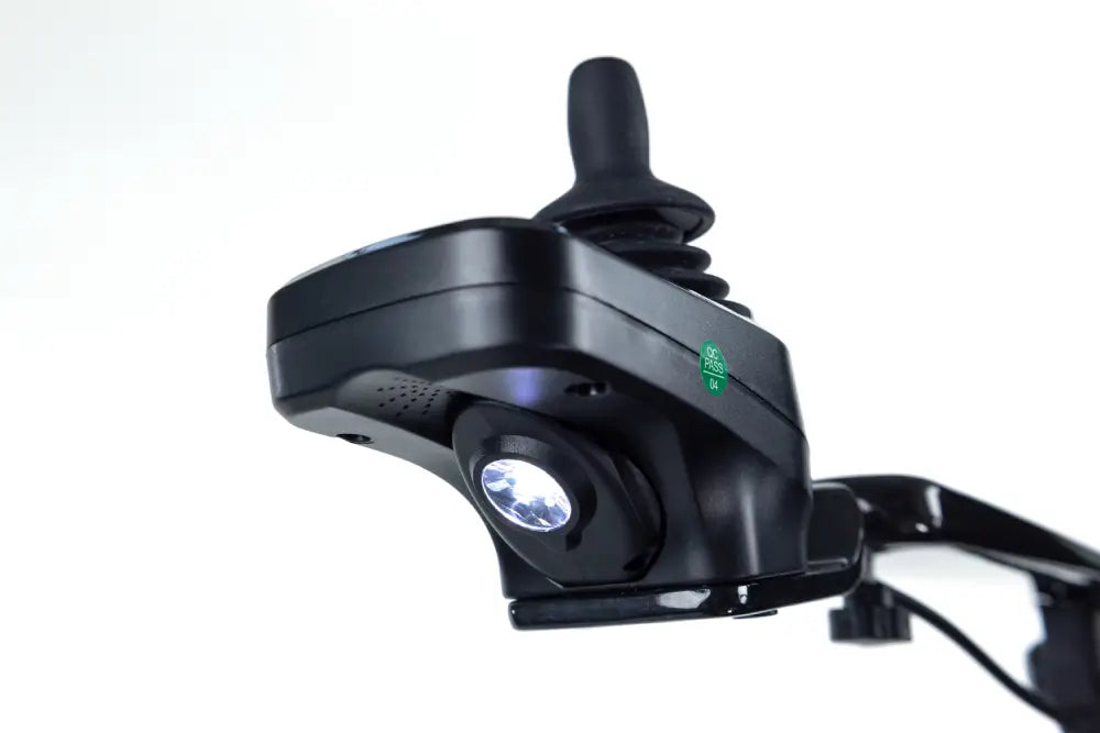 Close-up of the Monarch Mobility Ezi-Fold Carbon joystick controller with its built-in LED pathway light illuminated.