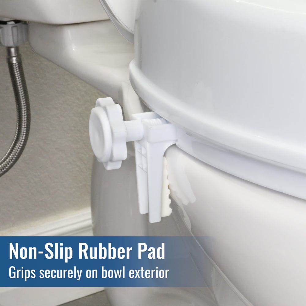 A white non-slip rubber pad clip mounted on the exterior of a white toilet bowl, with a text overlay at the bottom reading 'Non-Slip Rubber Pad' and 'Grips securely on bowl exterior'.