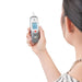Person using a digital ear thermometer on a white background