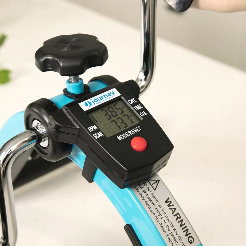 Digital tachometer attached to a piece of machinery on a light background