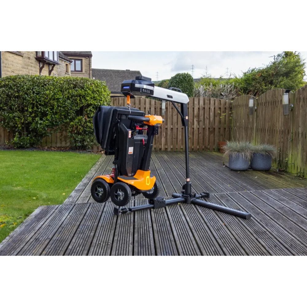 Garden leaf blower on a wooden deck with a garden and house in the background