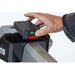 Hand inserting a battery into a power tool with a white background