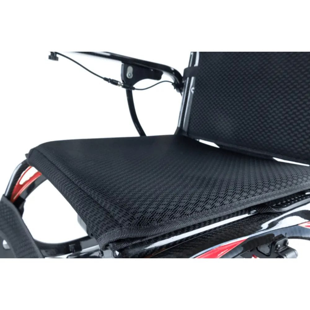 Black motorcycle seat with a textured pattern on a white background