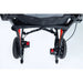 Close-up of a stroller's wheels and suspension mechanism on a white background