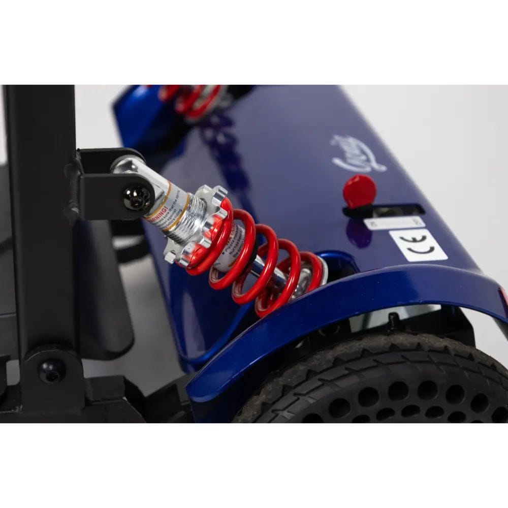Close-up of a blue vehicle with red shock absorbers on a white background