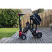 Foldable electric scooter with a child seat on a wooden deck