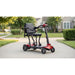 Mobility scooter on a sidewalk with a residential background