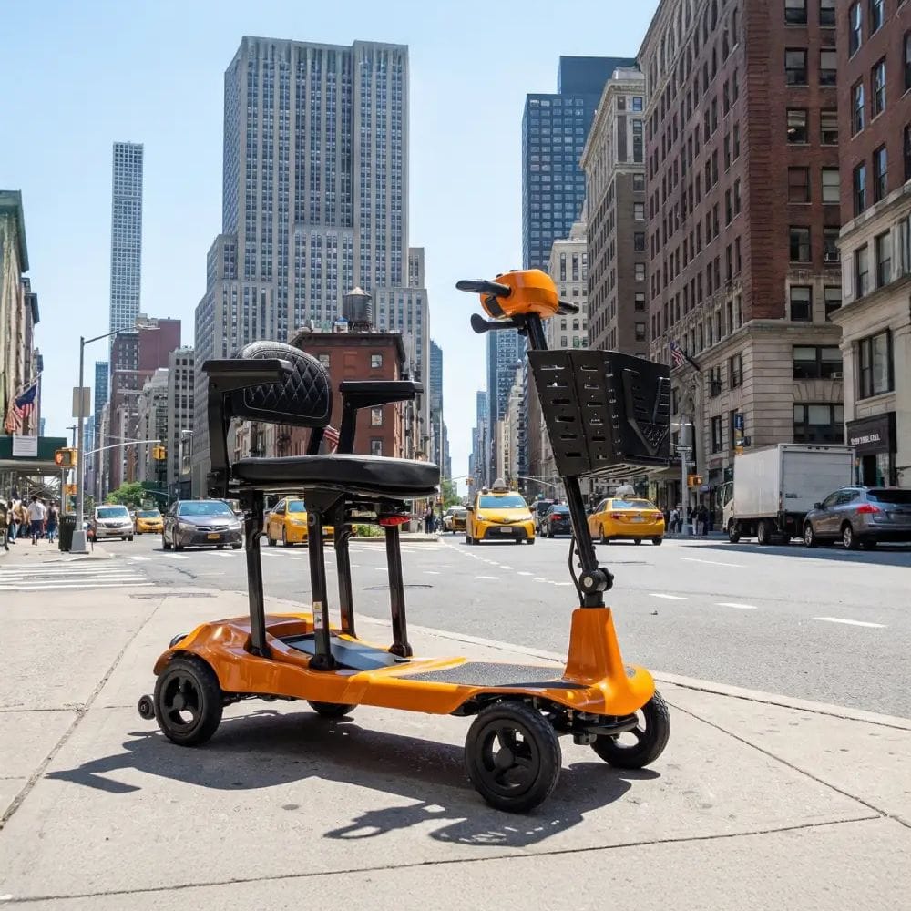 Orange electric scooter on a city street with tall buildings in the background
