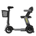 Gray and black three-wheeled mobility scooter with a basket on a white background
