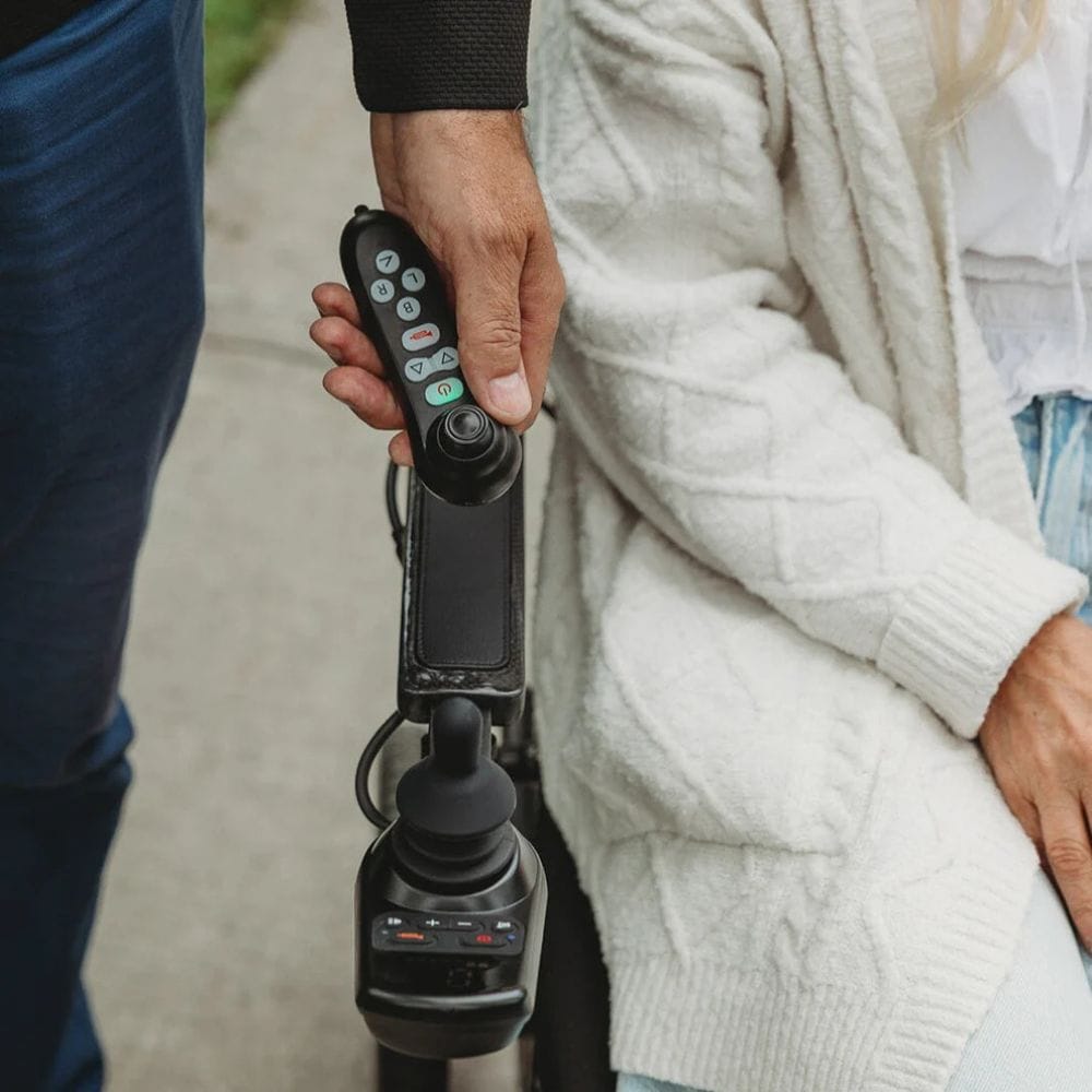 Person holding a remote control device with a blurred background