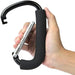 Hand holding a black carabiner with a metal clip on a white background