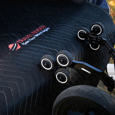 Close-up of a stroller with visible branding on a textured surface