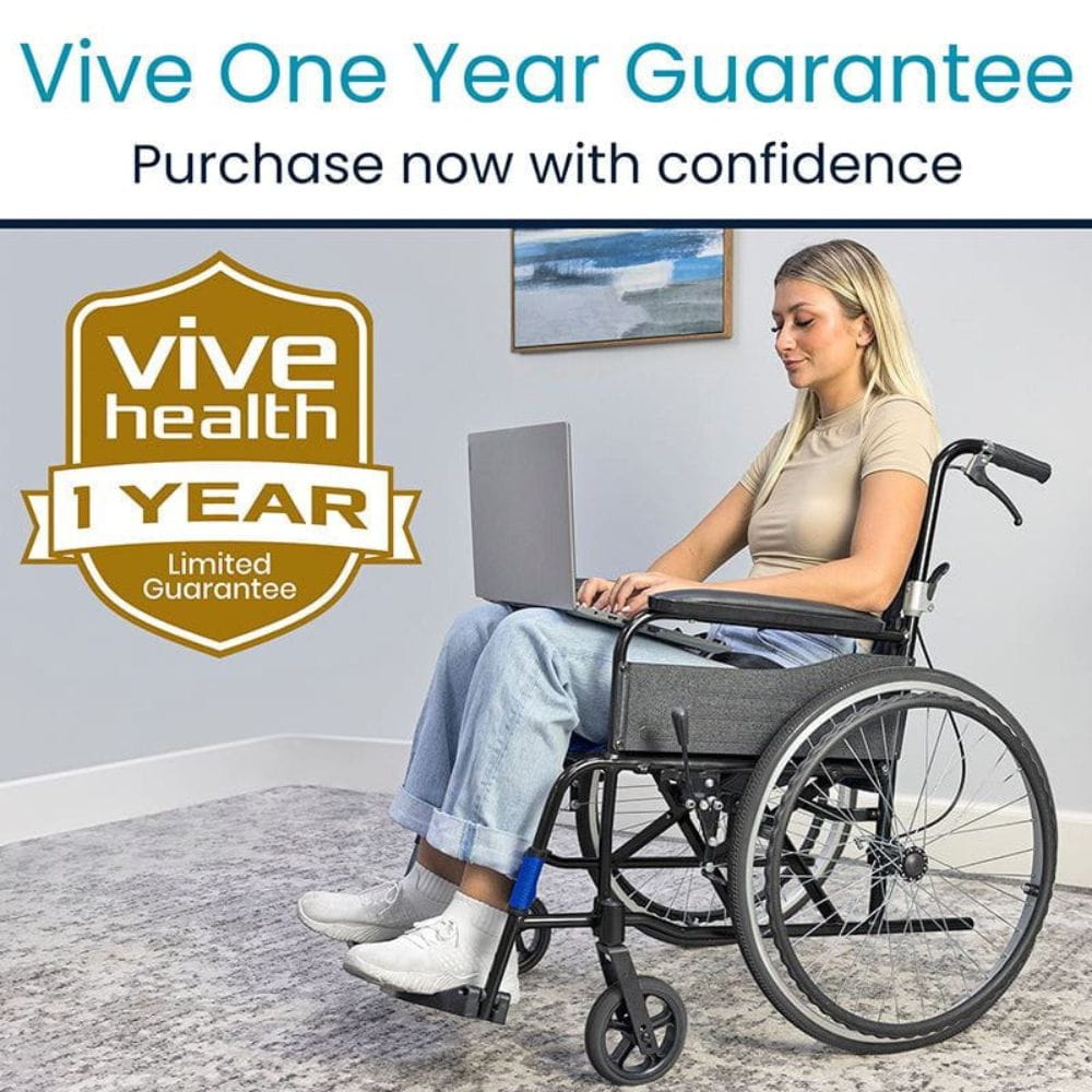 Woman in a wheelchair using a laptop with 'Vive Health' one-year guarantee badge.