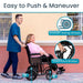 Person pushing a wheelchair with features highlighted, including smooth-riding wheels and dual hand brakes.