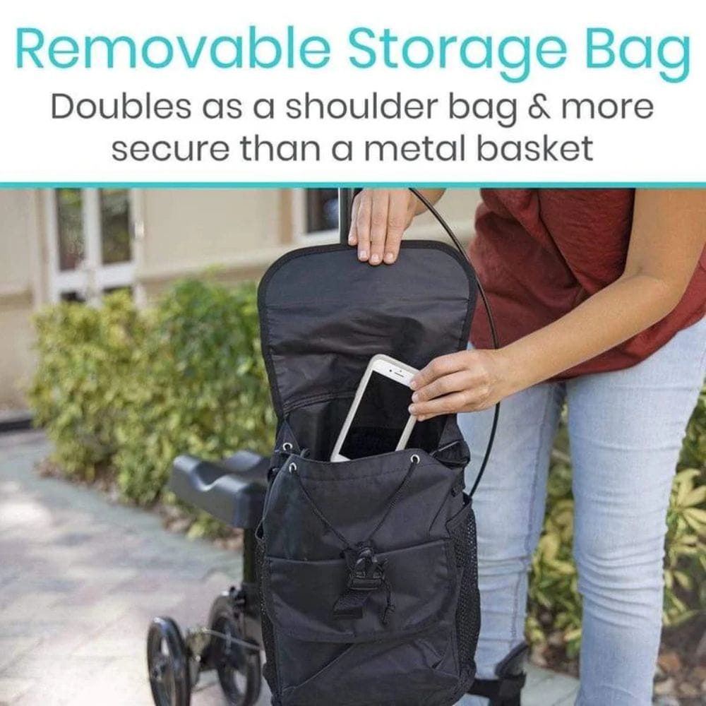Person holding a black removable storage bag with a stroller in the background