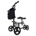 Black knee walker with a bag on a white background