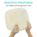 White fluffy cushion held by hands with text 'Machine Washable For daily and long term use' on a white background