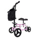 Pink knee walker with black bag on a white background