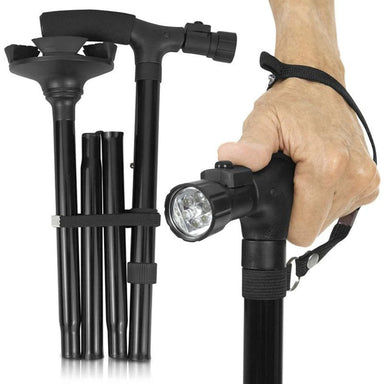 Black adjustable walking stick with flashlight attachment held by a hand on a white background