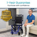 Man sitting on a couch next to a blue and black wheelchair with a 'Vive Health' one-year guarantee badge.