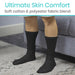 Person wearing black socks with text about skin comfort and fabric blend on a blurred background.